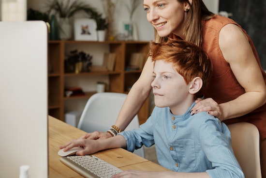 A mother and son searching online for an Adventist private school