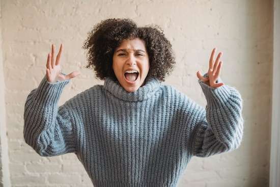 A woman raising her hands and yelling