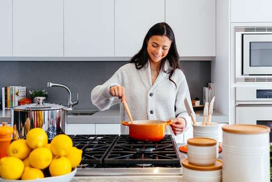 A woman cooking food ahead of time for Sabbath