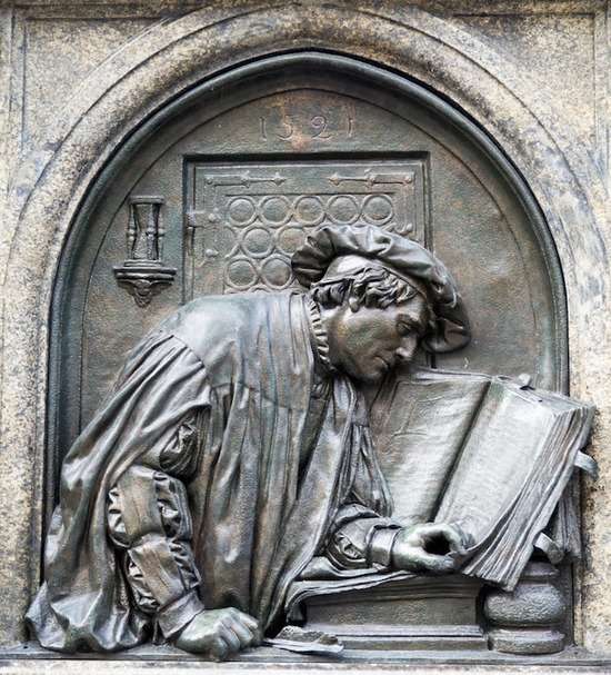 A statue of Martin Luther with a Bible
