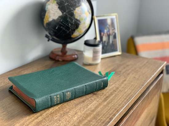  A green Protestant Bible on a desk