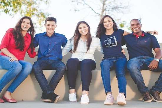 A group of happy students with arms linked at the Bahia Adventist College in Brazil