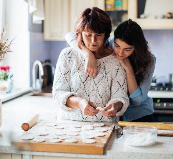 A daughter with her arms wrapped around her mother