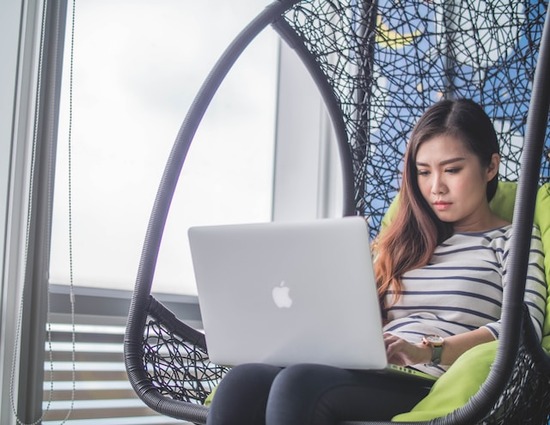 A young woman studying on her laptop