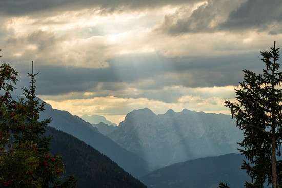 Light shining through clouds onto mountains