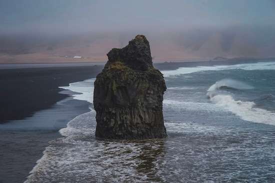 A large boulder on an ocean shore