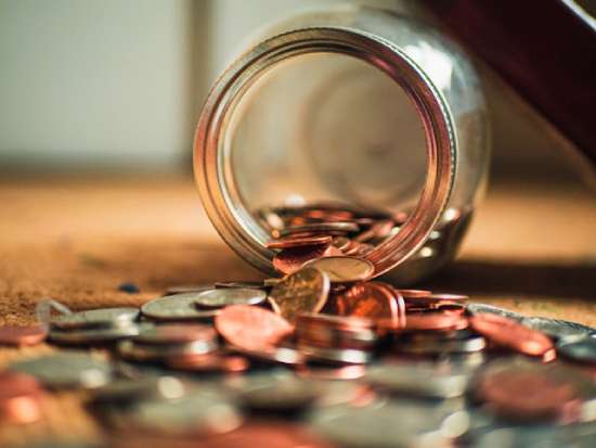 A jar with coins spilling out