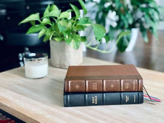 A New King James and King James Bible stacked on a table