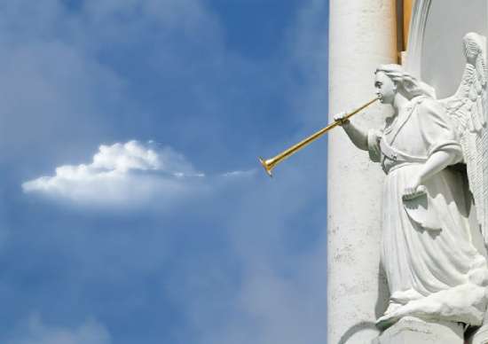 A statue of an angel blowing a trumpet as a warning