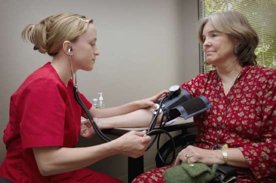 A nurse taking the blood pressure of a patient