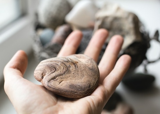 A hand holding a rock, like the one thrown at Ellen White