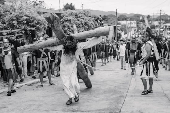 Jesus carrying the cross Jesus carrying a cross, surrounded by Roman soldiers