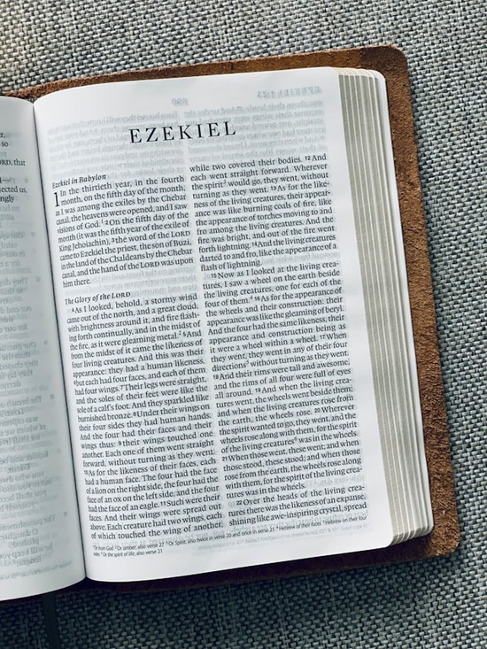 Bible open to Ezekiel A Bible open to Ezekiel 1 which speaks about living creatures in heaven