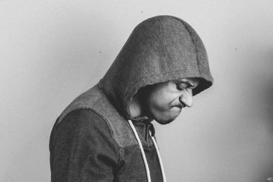 A Man who is Upset and Shows his Anger on his Face A man in a hoodie with an angry look on his face represents the older son in the Prodigal Son parable—who didn't understand or support his father's grace.