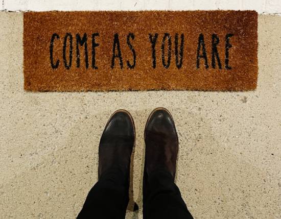 A doormat that says "Come as you are," represents the grace of God.