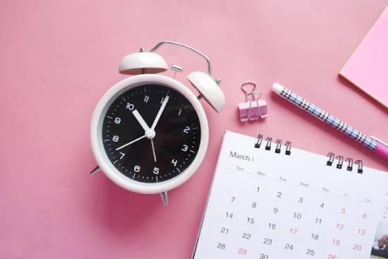 An alarm clock next to a calendar represents our desire to know when Jesus will return—even though the Bible doesn't tell us the exact date.