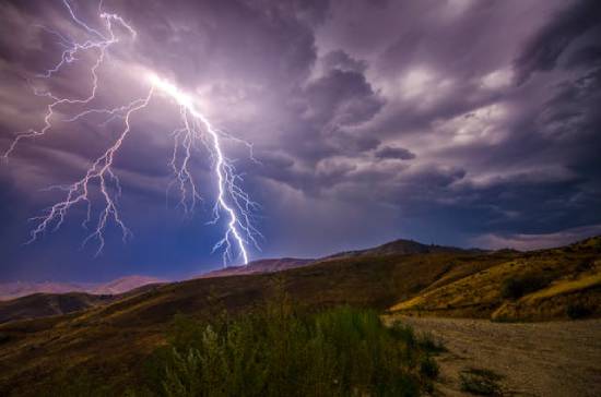 Thunder and Lightning over a Mountain Lightning striking a mountaintop.