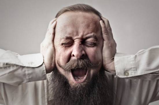 Man Screaming with his Hands over his Ears A man covers his ears while screaming, illustrating what may come to mind when hearing about demonic possession.