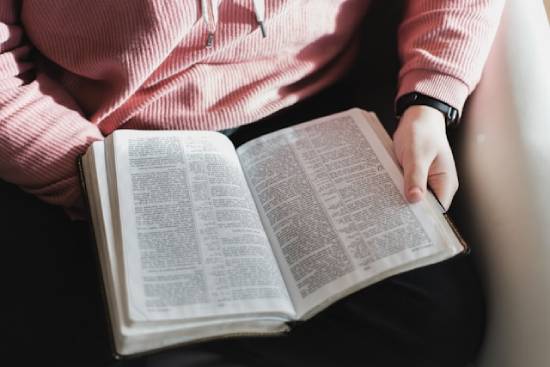 A person reading their Bible reminds us that Scripture has a lot to say about God's love, mercy, and forgiveness.