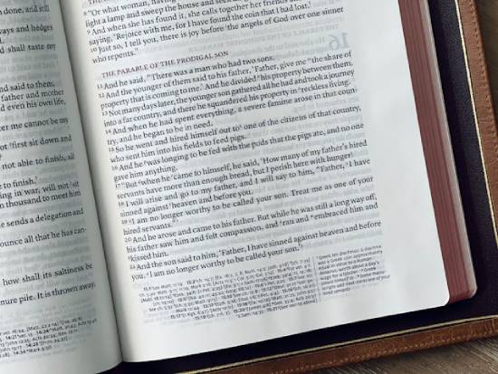 Bible open to the parable of the prodigal son in the book of Luke A Bible opened to The Parable of the Prodigal Son