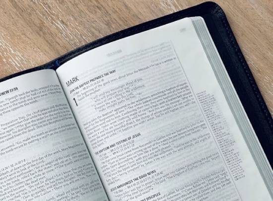 Black Bible open to the first page of the book of Mark A black Bible lies open to the first page of the book of Mark.