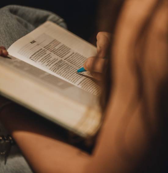 Woman reading and highlighting the book of Mark A woman highlights a verse in the first chapter of Mark.