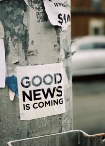 Good news is coming Posters attached to a post proclaiming that good news is coming.
