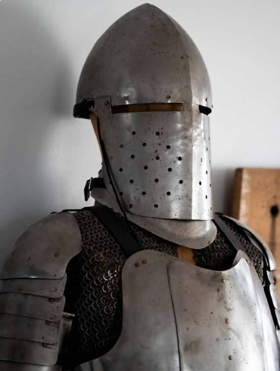 A Man Wearing The Armor A standing suit of medieval armor.