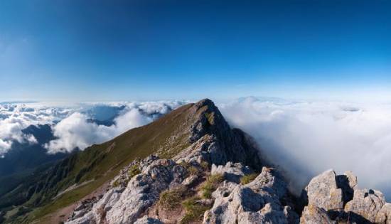 Top of a mountain in the clouds A mountain peak poking through the clouds